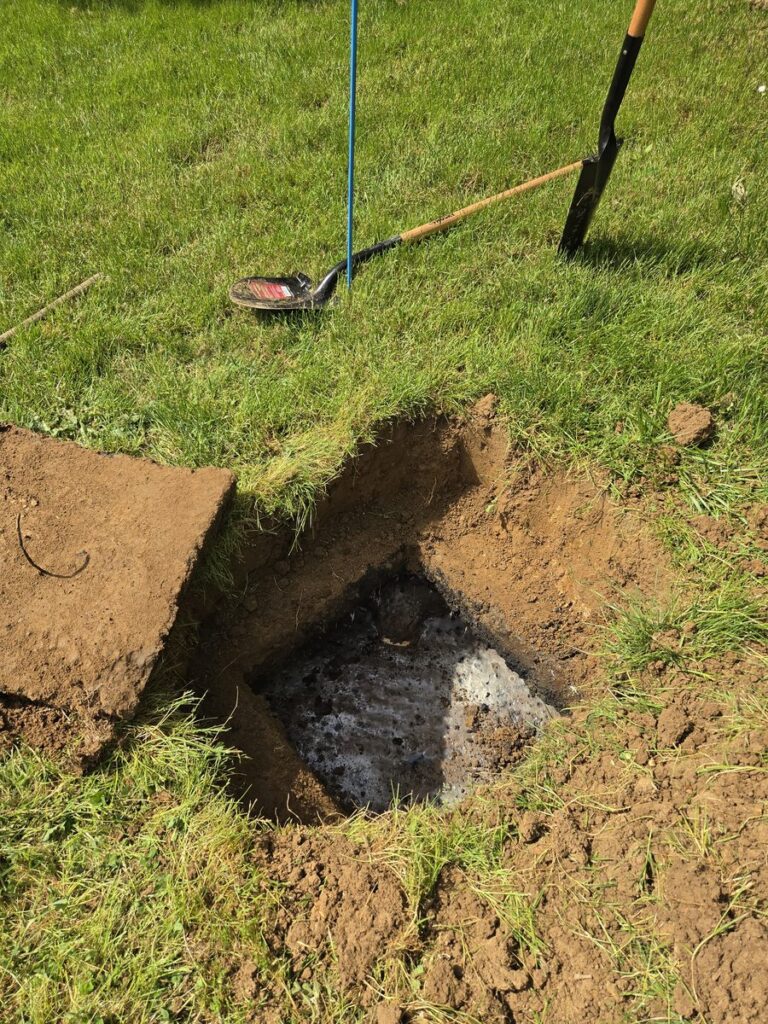 Open residential septic tank during a mid-service inspection in Marion County, Oregon — Stahr Septic Service checks system condition and reports findings during every septic pumping call.